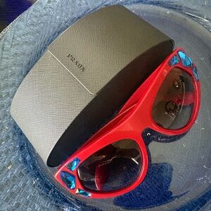 Prada blue Ornate Red Sunglasses with Black Lens Prada signature in Lens.